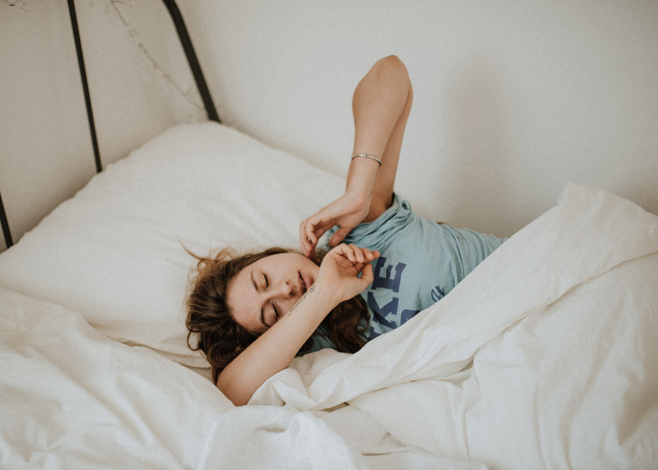 A silk sleep mask is great for travelling Female waking up in the morning