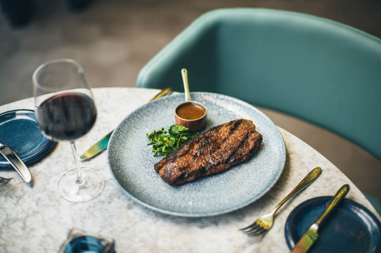 Steak dinner with glass of red wine