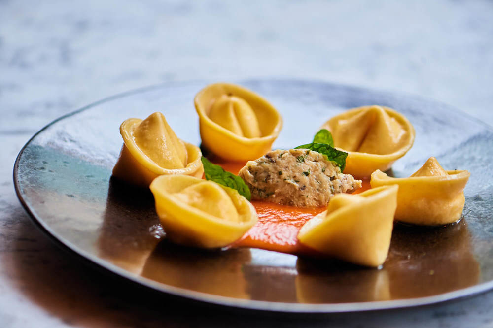 Burrata tortelloni with tomato fondue, aubergine and basil