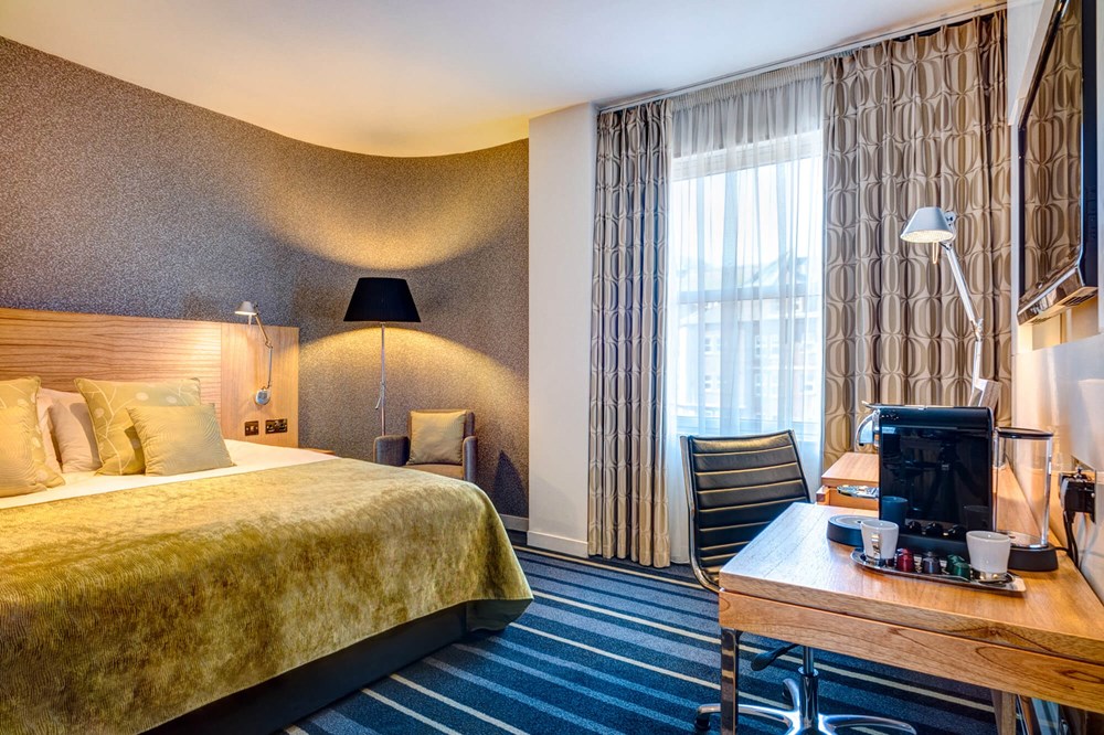 City Plus Room with queen-size bed, desk and Nespresso coffee machine at Apex City of Edinburgh Hotel