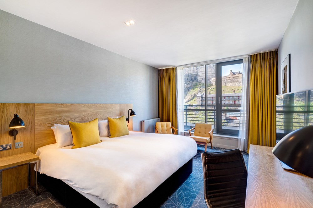 Castle View Deluxe Room with Balcony king-size bed at Apex Grassmarket Hotel