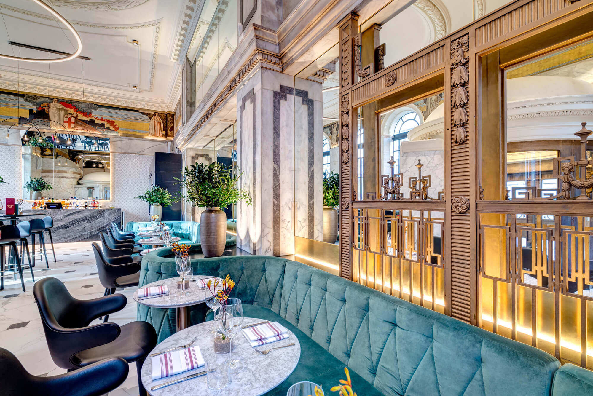 Empty Restaurant With Blue Velvet Seats & Gold Interior
