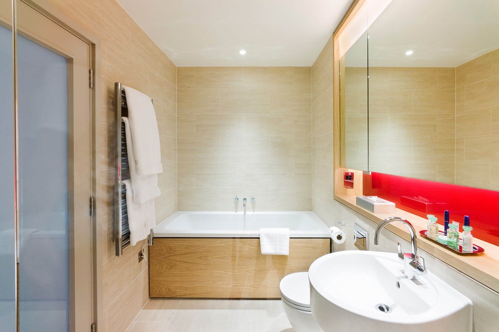 Bathroom with bath in Junior Suite at Apex Temple Court Hotel