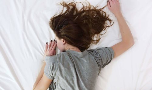 Drift off into a sumptuous slumber with Apex Hotels Woman sleeping on a bed
