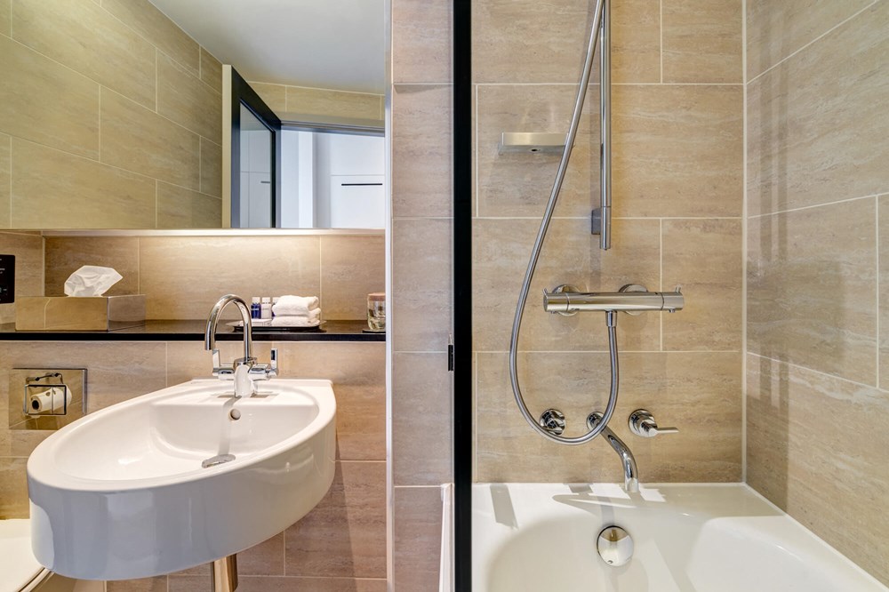 City Room bathroom with shower over bath at Apex Grassmarket Hotel