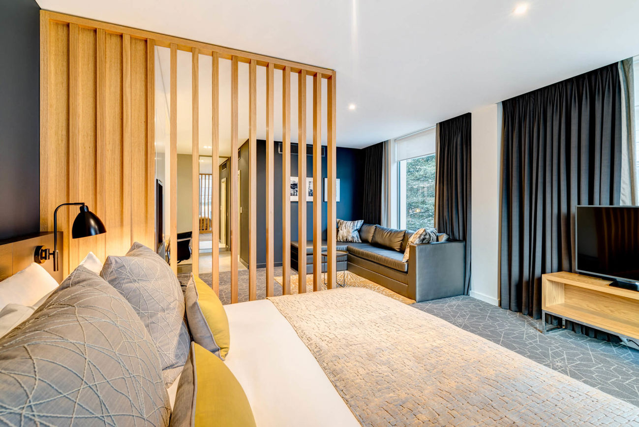 Deluxe Room with double bed and separate living area at Apex City of Bath Hotel