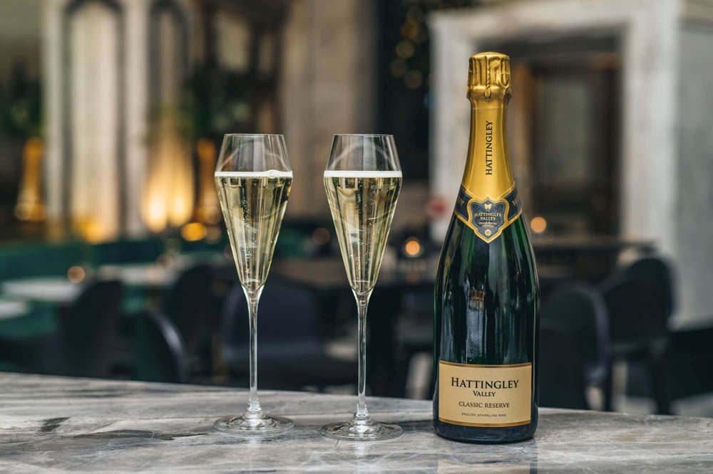 Champagne at Lazy Ballerinas Two filled glasses of fizz with unopened bottle next to them on Lazy Ballerinas bar