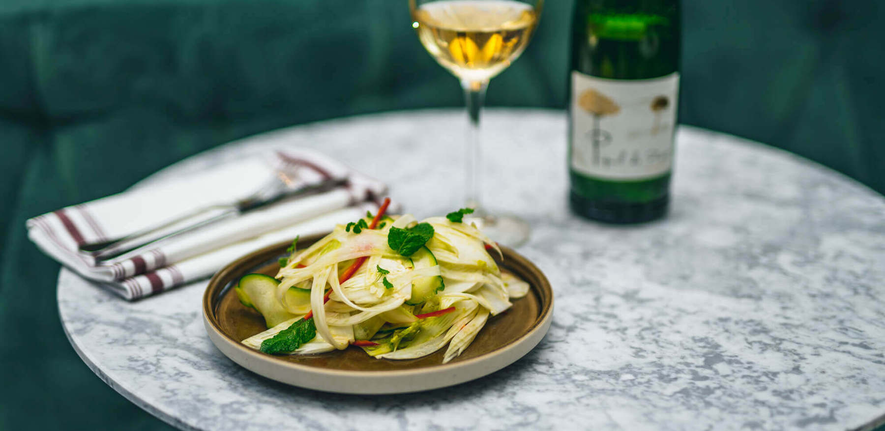 Food and wine at Lazy Ballerinas Bottle and glass of wine and pairing plate of food