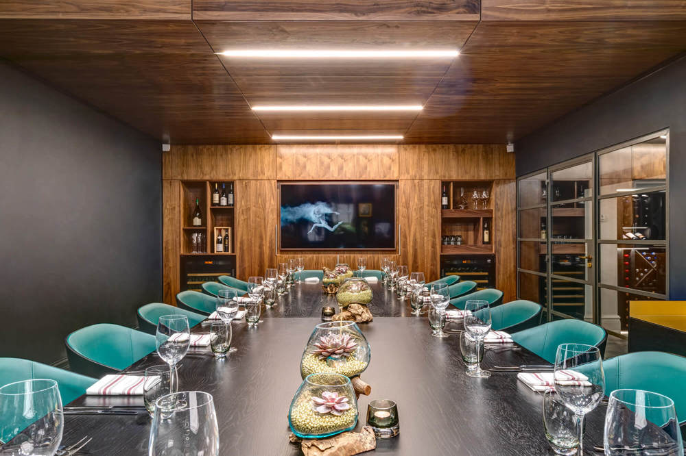 The Justice Room with wine cellar and table set up boardroom for private dining at Lazy Ballerinas wine bar