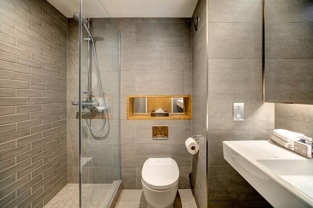 Standard Room bathroom with walk-in shower and sink