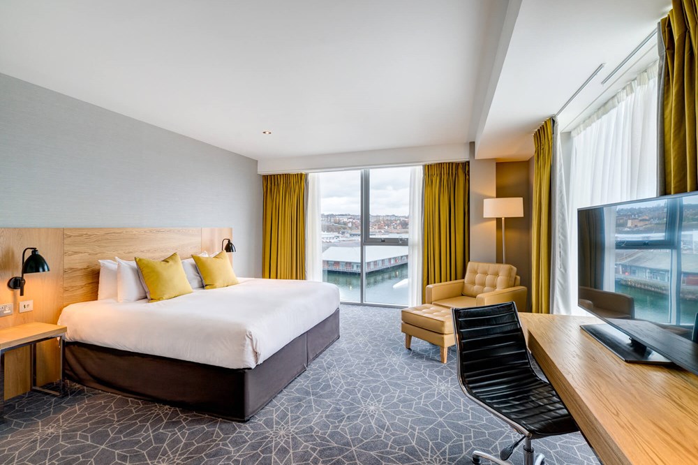 Quay View Superior Room with double bed and floor-to-ceiling windows at Apex City Quay Hotel & Spa