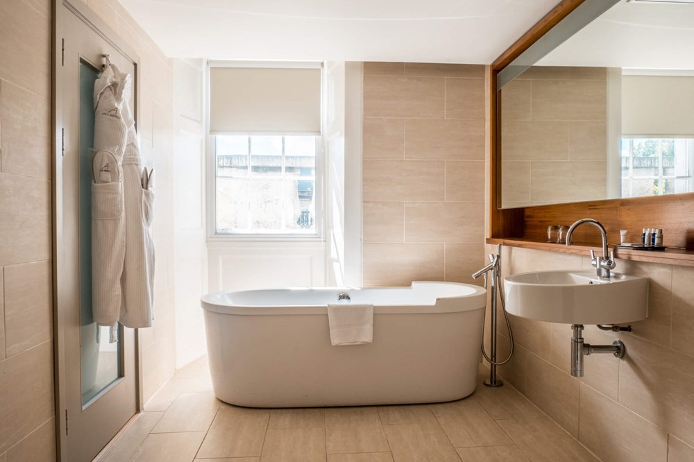 Master Suite bathroom with free standing bathtub at Apex Waterloo Place Hotel