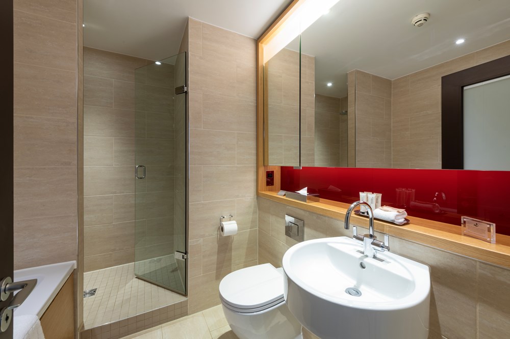 Deluxe Room bathroom with walk in shower at Apex Temple Court Hotel