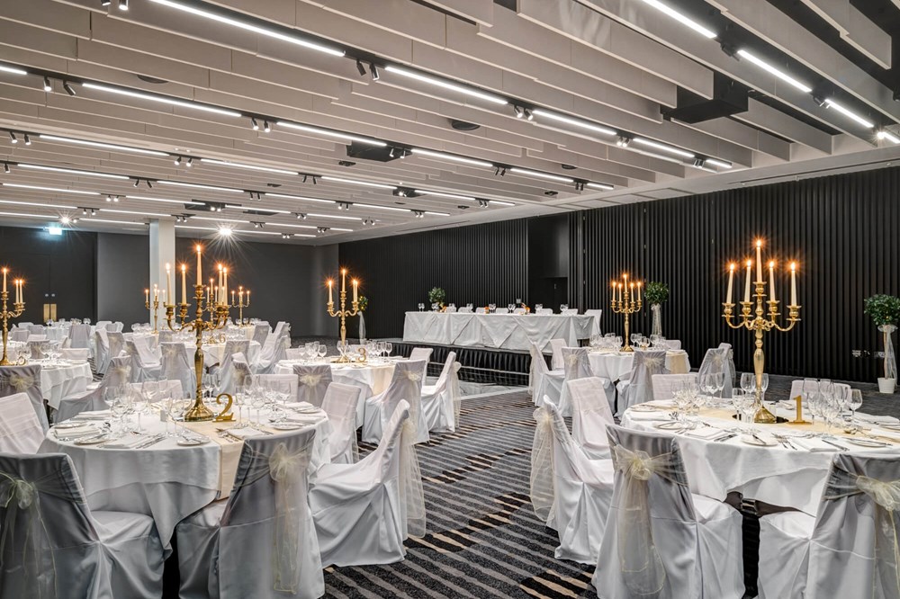 Lansdown Suite set for wedding with white tablecloths and gold candles