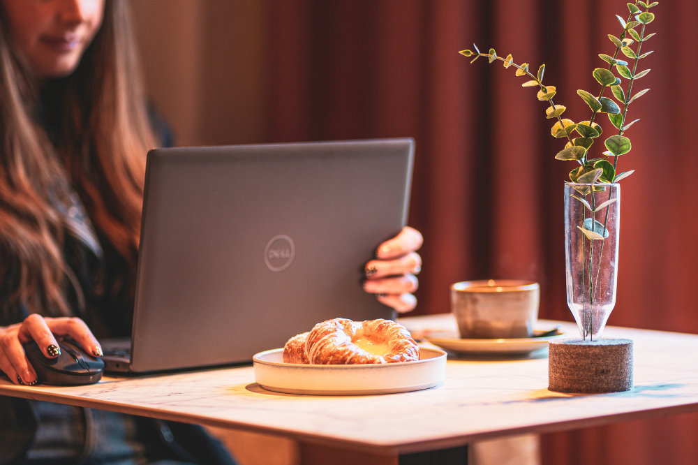 working at liberte cafe with coffee and pastry