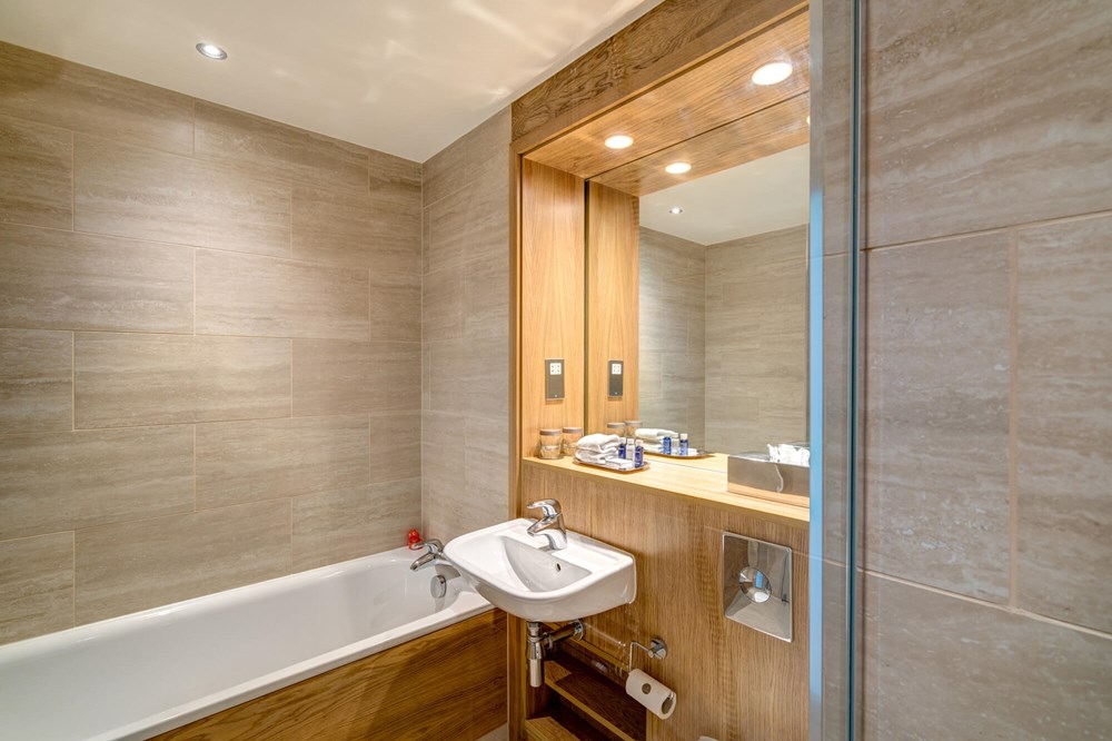 Bathroom with bath tub and sink with mirror