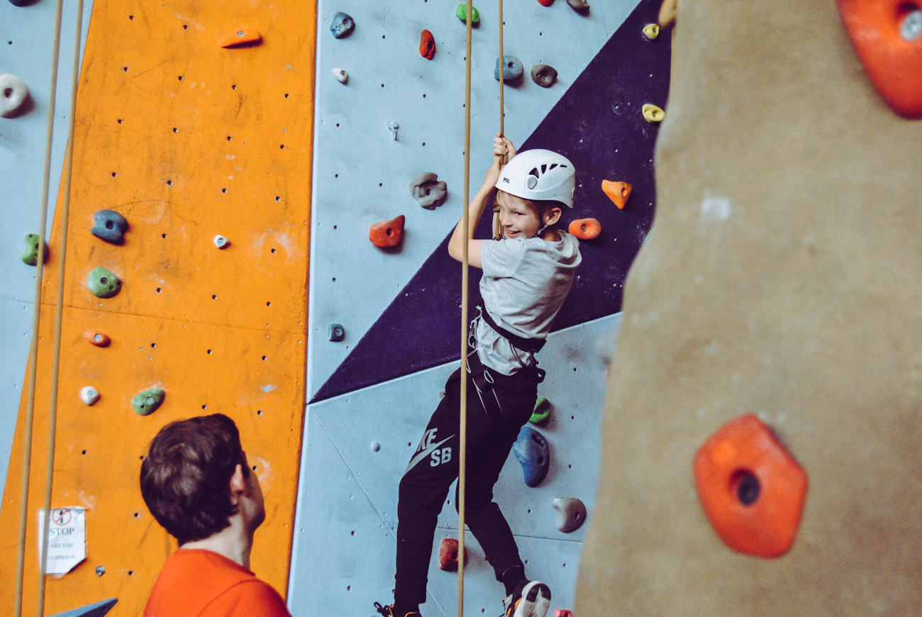 Climbing wall in Dundee Young boy abseiling down indoor climbing wall