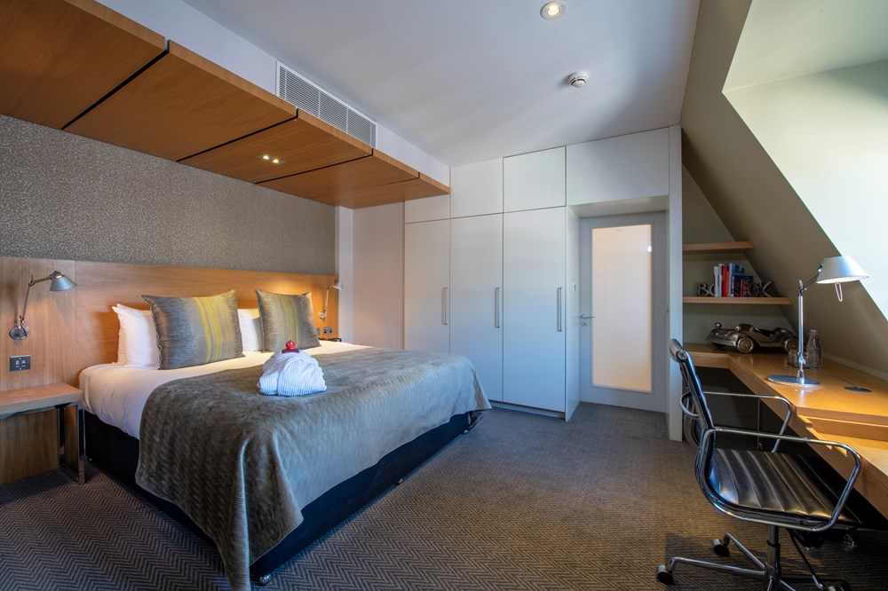 Master Suite bedroom with bed and desk at Apex Temple Court Hotel
