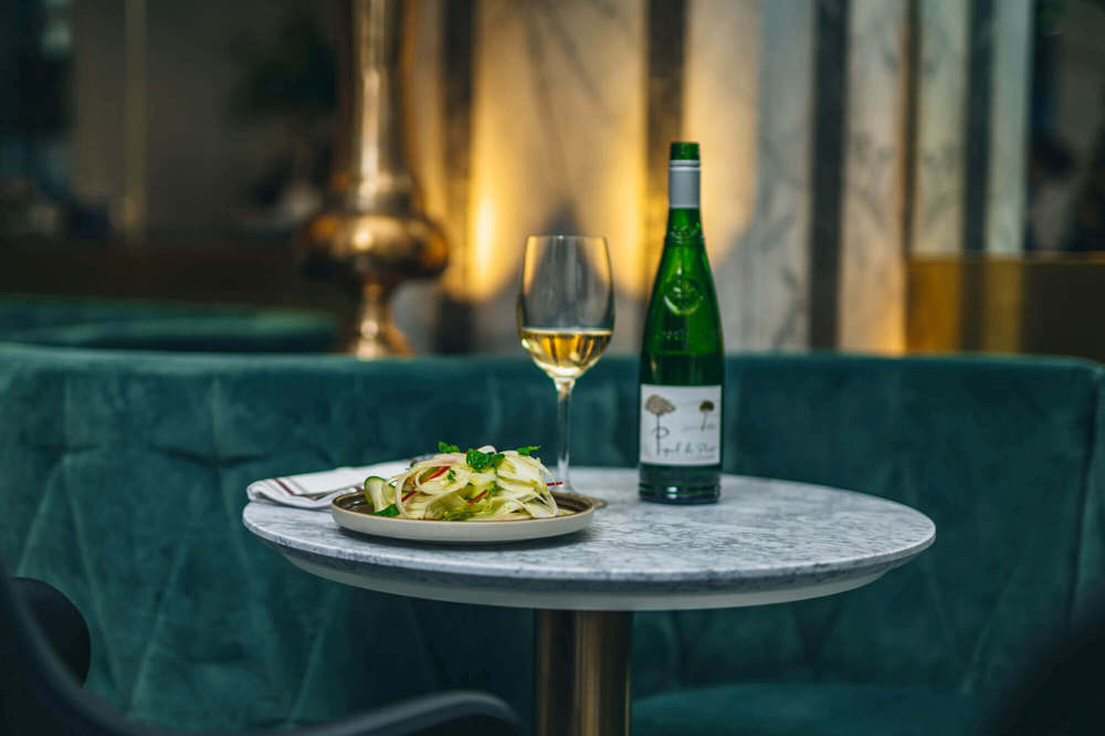 Food and wine at Lazy Ballerinas Bottle and glass of wine and pairing plate of food
