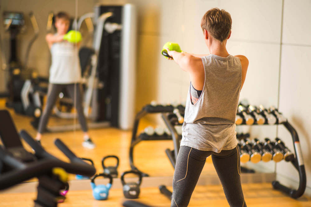 24-hour gym at Apex City of Bath Hotel Female guest working out in 24-hour gym at Apex City of Bath Hotel