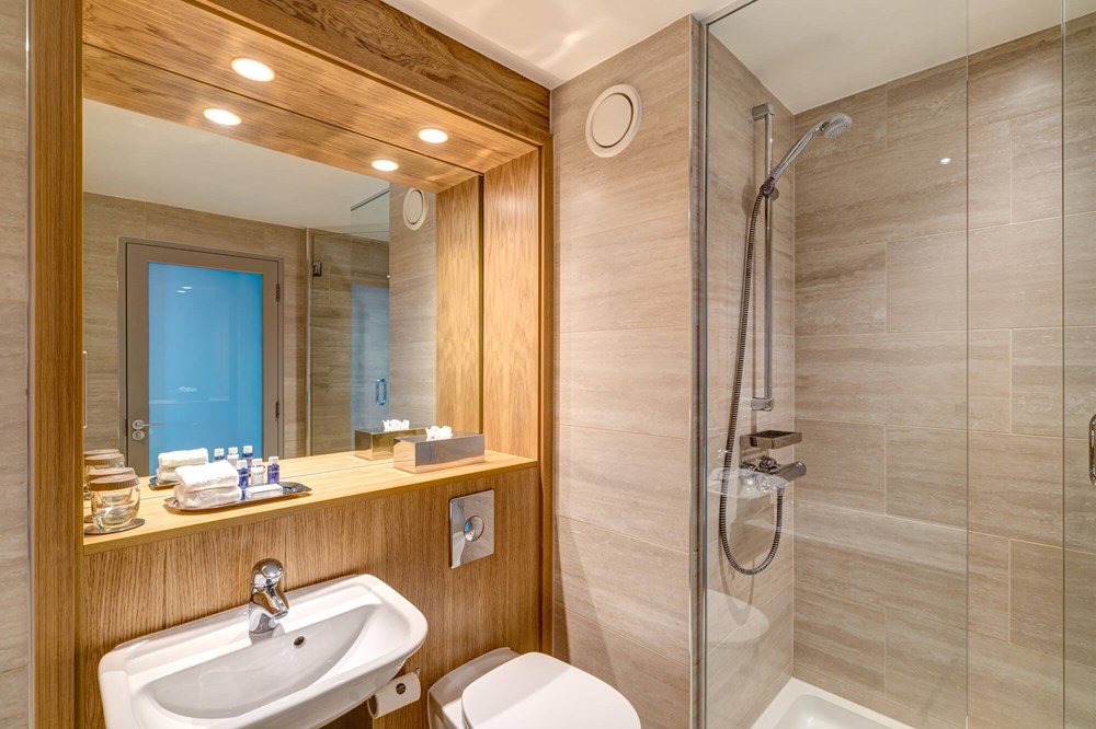 Family Room bathroom with walk-in shower at Apex City Quay Hotel & Spa