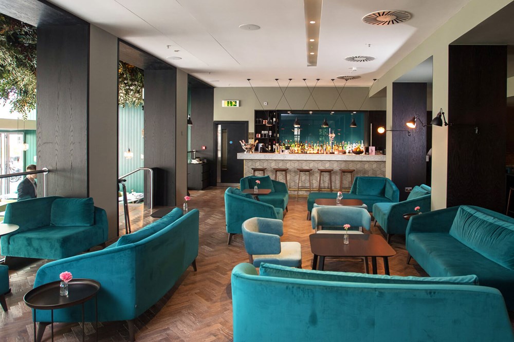 The Lampery, Seething Lane restaurant with plush velvet sofas and chairs in bar area