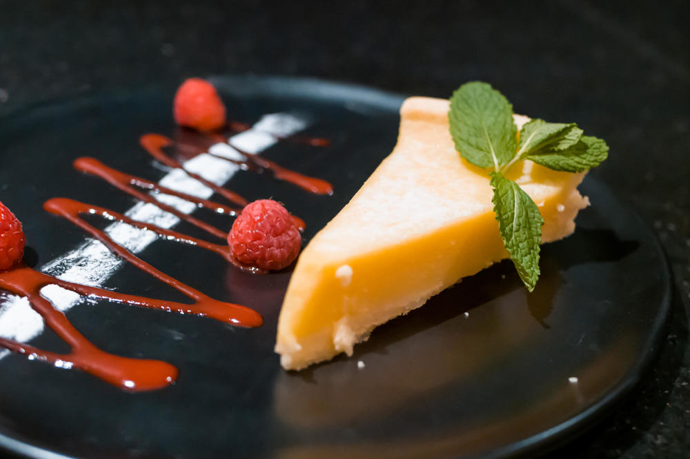 Dessert at The Orange Artichoke Lemon tart with raspberry coulis