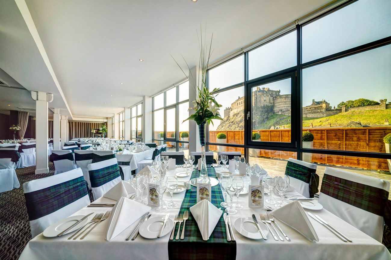 Heights at Apex Grassmarket Hotel dressed for private function, with floor length windows looking onto Edinburgh Castle
