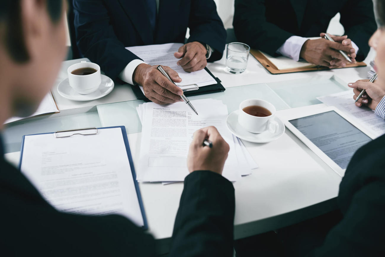 All your important documents stored in the one place Colleagues working over documents