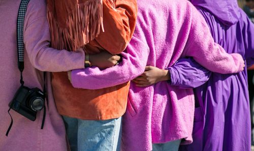 women with arms wrapped around each other women with arms wrapped around each other