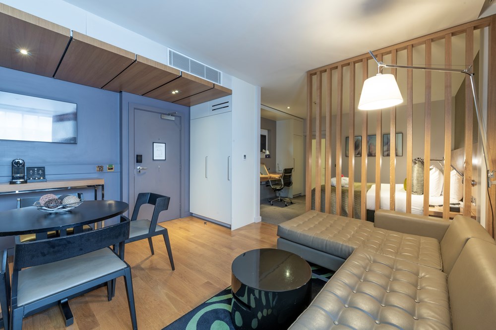 Living area with corner sofa in Junior Suite at Apex Temple Court Hotel