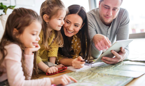 family pointing at a map family pointing at a map